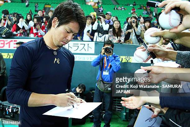 Pitcher Kenta Maeda of Samurai Japan signs autographs during the friendly match between Samurai Japan and Fukuoka SoftBank Hawks & Hokkaido Nipponham...