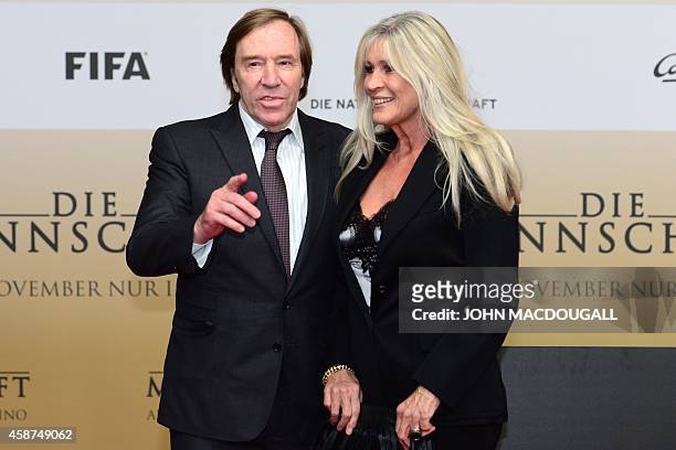 Former German football player Guenter Netzer and his wife Elvira arrive for a premiere screening of a documentary 'Die Mannschaft' on November 10,...