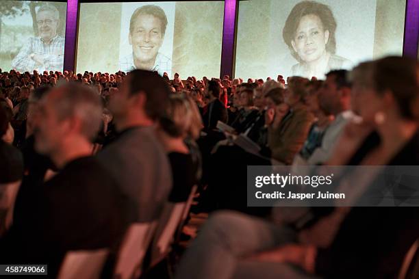 Images of the victims of the Malaysia Airlines Flight MH17 disaster are projected on the walls during a national commemoration ceremony at RAI on...