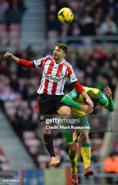 Fabio Borini of Sunderland and Johan Elmander of Norwich City battle for the ball during the Barclays Premier League match between Sunderland and...
