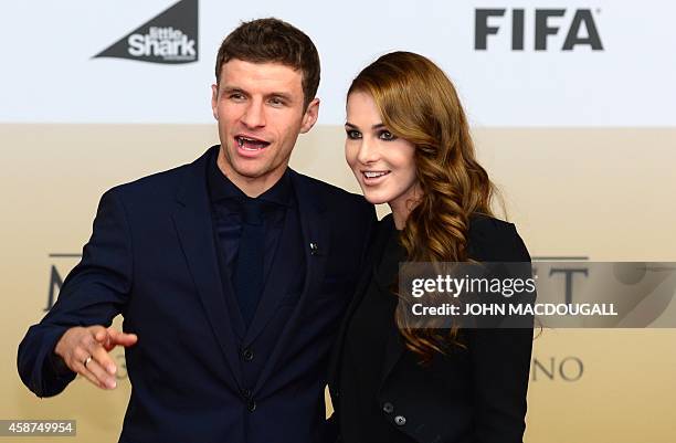 Germany's midfielder Thomas Mueller and his wife Lisa arrive for a premiere screening of a documentary 'Die Mannschaft' , the national German...