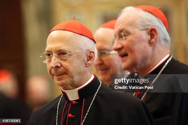 Italian Cardinal Angelo Bagnasco and Canadian Cardinal Marc Ouellet wait to exchange Christmas greetings with Pope Francis at the Clementina Hall on...