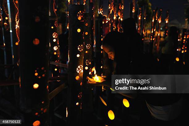 People pray for the victims during the candlelight memorial on November 8, 2014 in Tacloban, Leyte, Philippines. People lined the roads with candles...