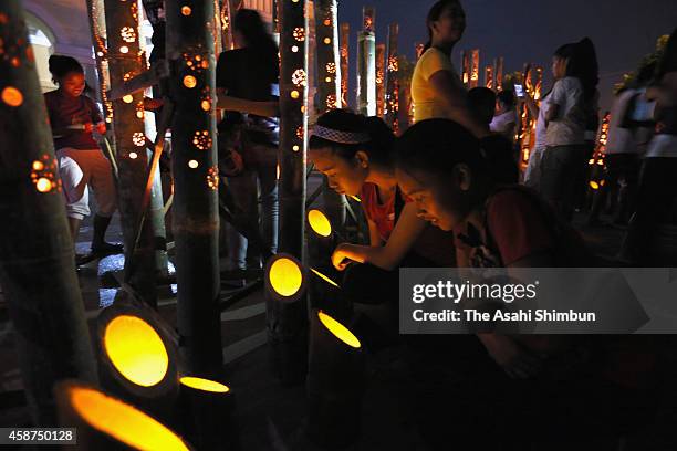 People pray for the victims during the candlelight memorial on November 8, 2014 in Tacloban, Leyte, Philippines. People lined the roads with candles...