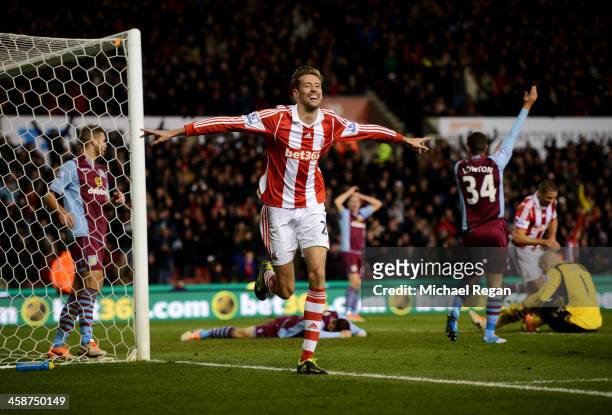 Peter Crouch of Stoke City celebrates as he scores their second goal during the Barclays Premier League match between Stoke City and Aston Villa at...