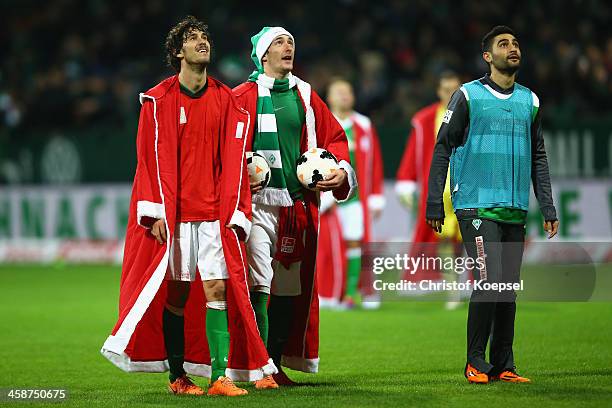 Santiago Garcia, Luca Caldirola and Mehmet Ekici of Bremen celebrate after the Bundesliga match between Werder Bremen and Bayer Leverkusen at...