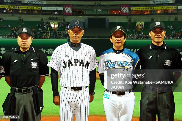 Head Coach Hiroki Kokubo of Samurai Japan and Head Coach Hideki Kuriyama of Hokkaido Nippon-Ham Fighters poses during the friendly match between...