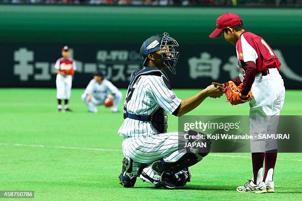 Catcher Motohiro Shima of Samurai Japan sakes hand during the friendly match between Samurai Japan and Fukuoka SoftBank Hawks & Hokkaido Nipponham...