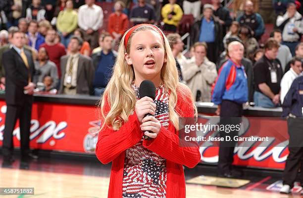 Performer Taylor Swift sings the National Anthem prior to the game of the Detroit Pistons against the Philadelphia 76ers on April 5, 2002 at the...