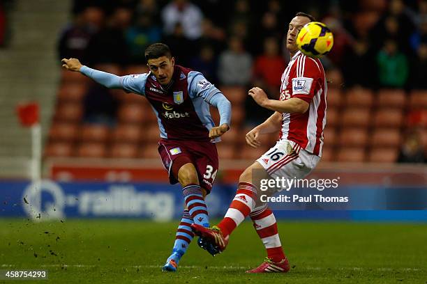 Charlie Adam of Stoke in action with Matthew Lowton of Aston Villa during the Barclays Premier League match between Stoke City and Aston Villa at the...