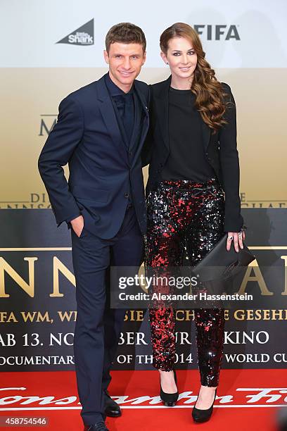 Thomas Mueller of the German national football team arrives with his wife Lisa Mueller for the movie premiere 'Die Mannschaft' at Sony Center Berlin...