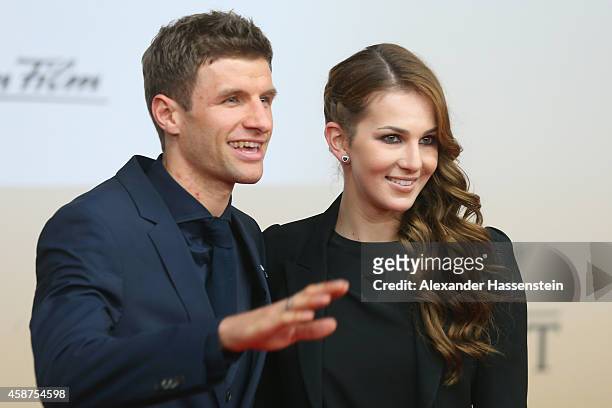 Thomas Mueller of the German national football team arrives with his wife Lisa Mueller for the movie premiere 'Die Mannschaft' at Sony Center Berlin...
