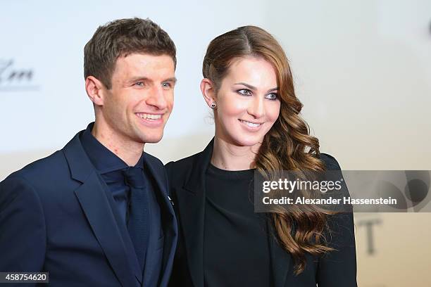 Thomas Mueller of the German national football team arrives with his wife Lisa Mueller for the movie premiere 'Die Mannschaft' at Sony Center Berlin...