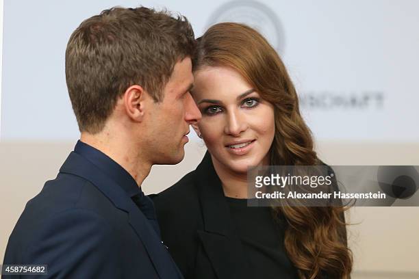 Thomas Mueller of the German national football team arrives with his wife Lisa Mueller for the movie premiere 'Die Mannschaft' at Sony Center Berlin...