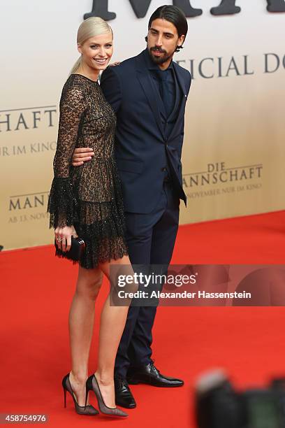 Sami Khedira of the German national football team arrives with Lena Gercke for the movie premiere 'Die Mannschaft' at Sony Center Berlin on November...