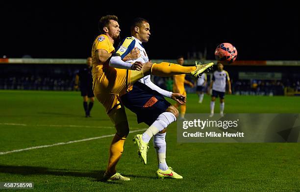 Josh Huggins of Havant is challenged by Scott Wiseman of Preston during the FA Cup First Round match between Havant & Waterlooville FC and Preston...
