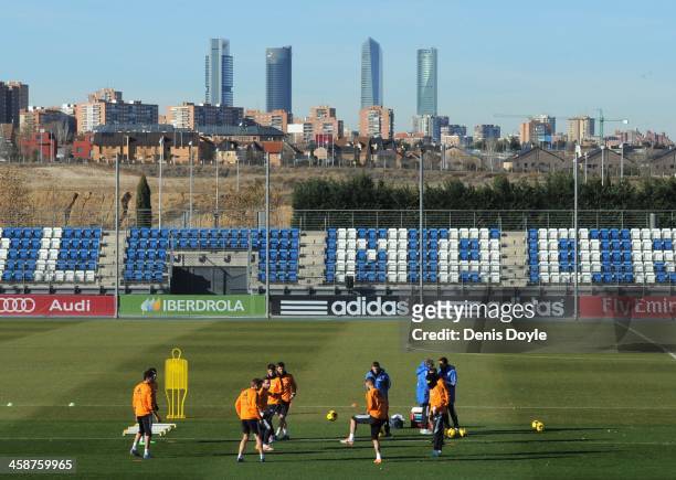 Real Madrid players train at the Valdebebas training ground with the Madrid Four Towers skyscrapers in the background on December 21, 2013 in Madrid,...