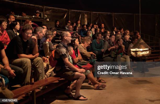 Spectators listen to explanations about how donations work for fundraising for the Phare circus on December 21, 2013 in Battambang, Cambodia. Almost...