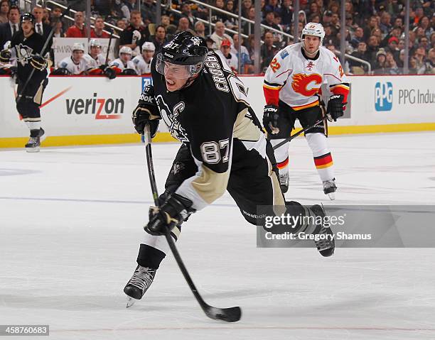 Sidney Crosby of the Pittsburgh Penguins takes a shot and scores during the second period against the Calgary Flames on December 21, 2013 at Consol...