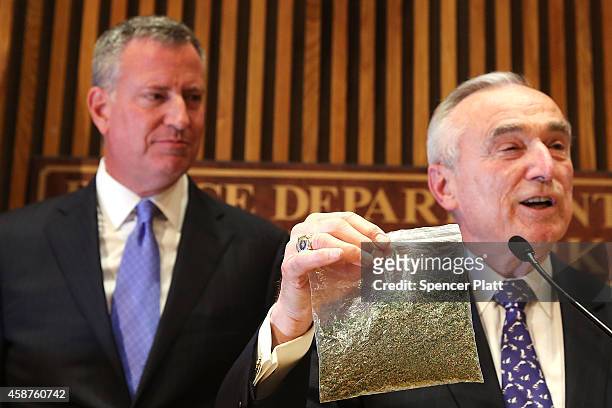 New York City Police Commissioner Bill Bratton holds up a bag of oregano to demonstrate what 25 grams of marijuana looks like at a news conference to...