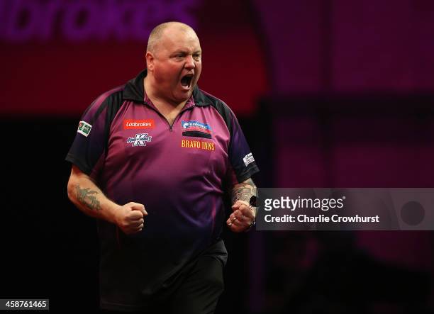 Andy Hamilton of England celebrates winning a leg during his second round match against Richie Burnett of Wales during the Ladbrokes.com World Darts...