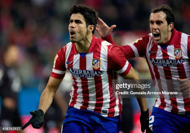 Diego Costa of Atletico de Madrid celebrates scoring their second goal with team-mate Diego Godin during the La Liga match between Club Atletico de...