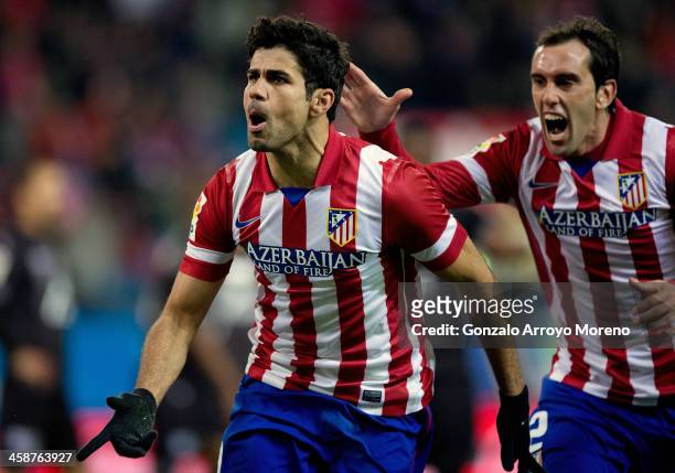 Diego Costa of Atletico de Madrid celebrates scoring their second goal with team-mate Diego Godin during the La Liga match between Club Atletico de...