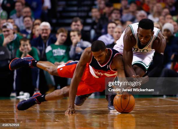 Jeff Green of the Boston Celtics and Trevor Ariza of the Washington Wizards scrambles for a loose ball in the second half during the game at TD...