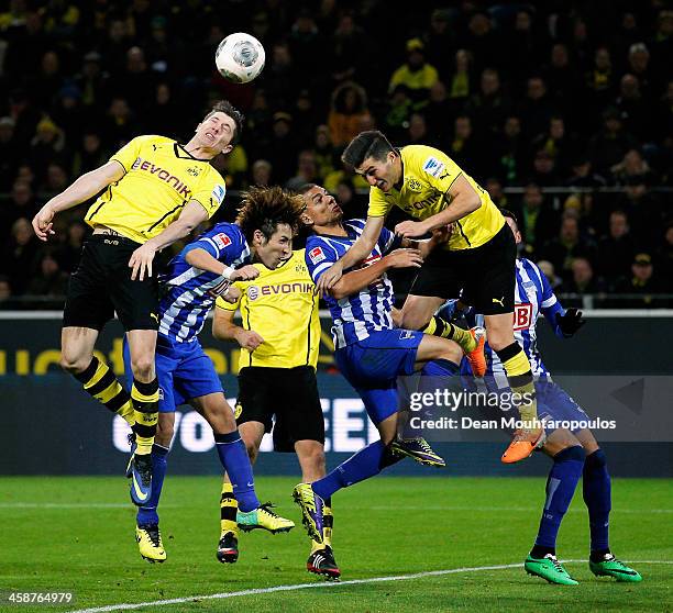 Robert Lewandowski and Nuri Sahin of Dortmund and Hajime Hosogai and Marcel Ndjeng of Hertha challenge for the header during the Bundesliga match...