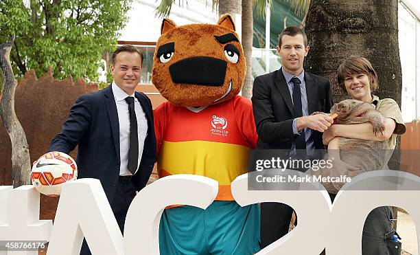 Mark Bosnich and Brett Emerton pose with AFC Asian Cup official mascot Nutmeg the wombat and a wombat at Wild Life Sydney Zoo on November 11, 2014 in...