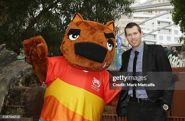 Brett Emerton poses with AFC Asian Cup official mascot Nutmeg the wombat at Wild Life Sydney Zoo on November 11, 2014 in Sydney, Australia.