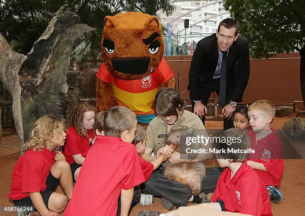 Brett Emerton poses with AFC Asian Cup official mascot Nutmeg the wombat at Wild Life Sydney Zoo on November 11, 2014 in Sydney, Australia.