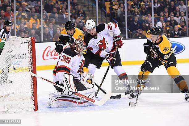 Carl Soderberg of the Boston Bruins scores a goal against Cory Schneider of the New Jersey Devils at the TD Garden on November 10, 2014 in Boston,...