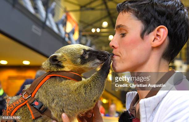 Coati "Sunny" and owner Nicolle Mueller set a world record for putting the most coins in a money box by a coati in one minute. Record at at Holmes...