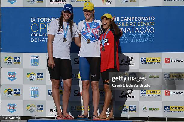 Alessandra Marchioro, Graciele Herrmann and Daynara Ferreira Paula pose for a photo after competing in the women's 50m freestyle during the 23...