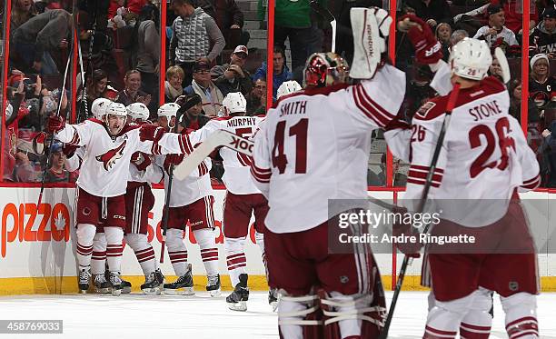 Keith Yandle of the Phoenix Coyotes celebrates on overtime win against the Ottawa Senators with teammates at Canadian Tire Centre on December 21,...