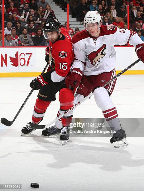 Clarke MacArthur of the Ottawa Senators battles for puck possession against Connor Murphy of the Phoenix Coyotes at Canadian Tire Centre on December...