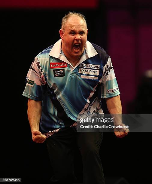 Ian White of England celebrates winning his second round match against Kim Huybrechts of Belgium during the Ladbrokes.com World Darts Championship on...