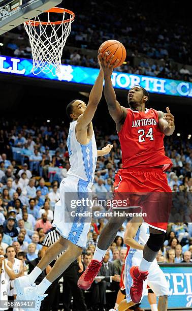 Brice Johnson of the North Carolina Tar Heels defends against a shot by De'Mon Brooks of the Davidson Wildcats during a game at the Dean Smith Center...