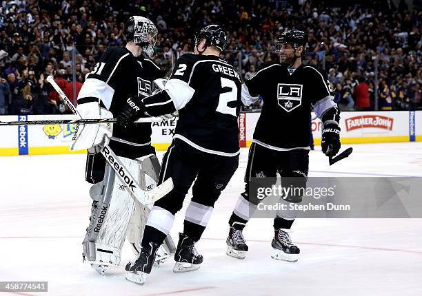 Goalie Martin Jones of the Los Angeles Kings is greeted by Matt Greene and Slava Voynov after Jones stopped all three Colorado Avalanche shots in the...