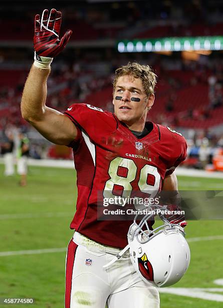 Tight end John Carlson of the Arizona Cardinals waves as he walks off the field following the NFL game against the St. Louis Rams at the University...