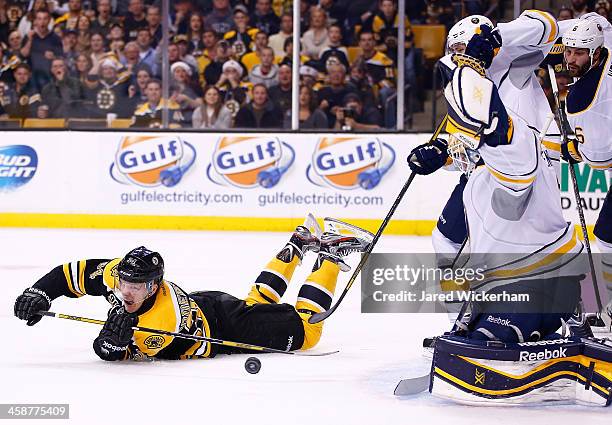 Carl Soderberg of the Boston Bruins shoots from his stomach in the first period in front of Jhonas Enroth of the Buffalo Sabres during the game at TD...