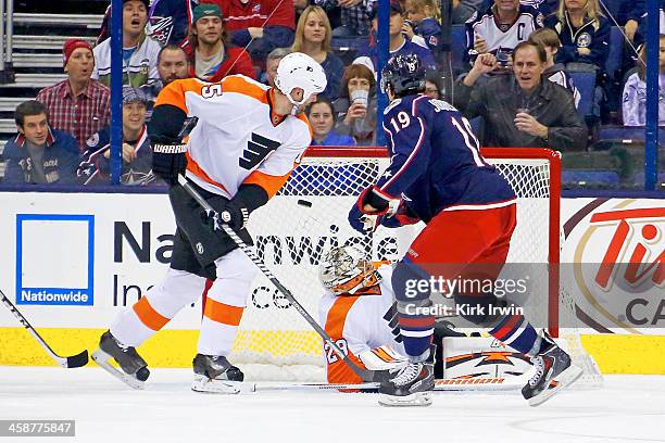 Hal Gill of the Philadelphia Flyers watches as Ryan Johansen of the Columbus Blue Jackets beats Ray Emery of the Philadelphia Flyers for a goal...