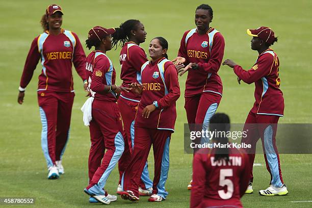 Anisa Mohammed of the West Indies celebrates with her team after taking a wicket during game one of the women's One Day International series between...