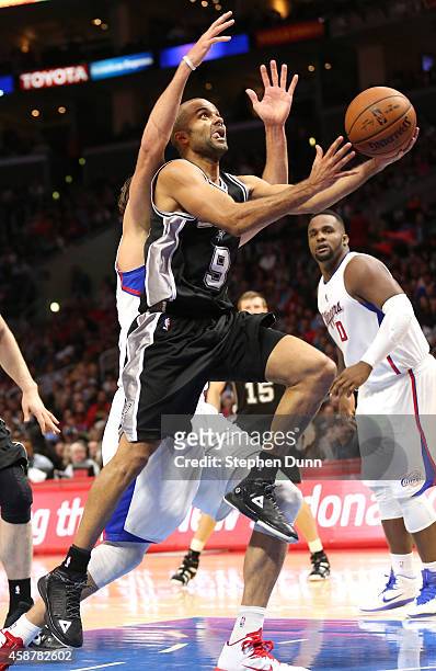 Tony Parker of the San Antonio Spurs shoots past Spencer Hawes of the Los Angeles Clippers at Staples Center on November 10, 2014 in Los Angeles,...