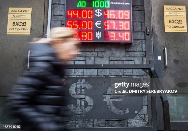 Woman walks past a currency exchange point in central Moscow on November 11, 2014. Russia's central bank said Monday it is floating the ruble and...