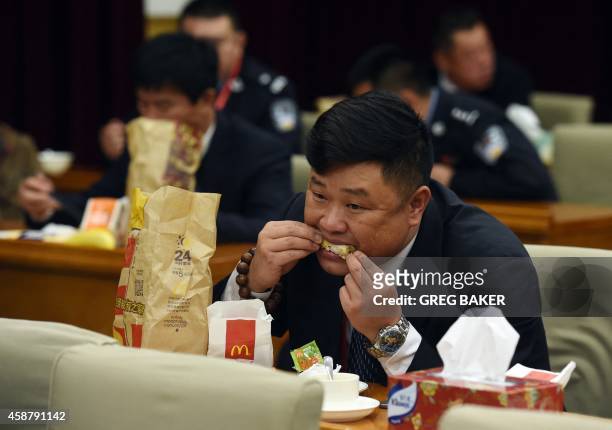 Staff member at the Zhongnanhai leadership compound eats McDonalds for dinner, while US President Barack Obama has a private dinner with Chinese...