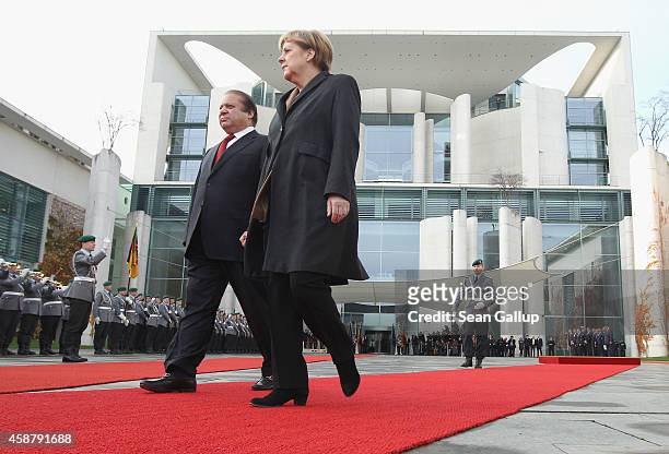 German Chancellor Angela Merkel and Pakistani Prime Minister Nawaz Sharif review a guard of honour upon Sharif's arrival at the Chancellery on...