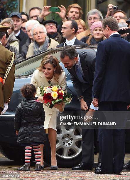 Spanish Queen Letizia receives flowers a young girl as she is welcomed with her husband Spanish King Felipe VI by Grand Duke Henri of Luxembourg ,...