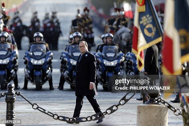 French President Francois Hollande wearing a bluberry flower, tribute to the WWI French soldiers, attends a ceremony to commemorate the end of the...